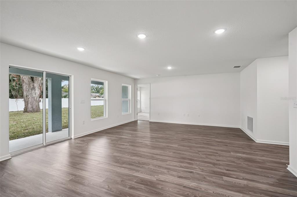 2155 Northwest 23rd Loop Ocala, FL 34475 - Photo 13 of 24 a view of an empty room with wooden floor and a window