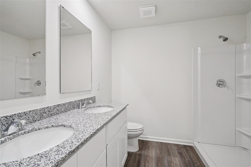 2155 Northwest 23rd Loop Ocala, FL 34475 - Photo 3 of 24 a bathroom with a granite countertop sink a toilet and shower