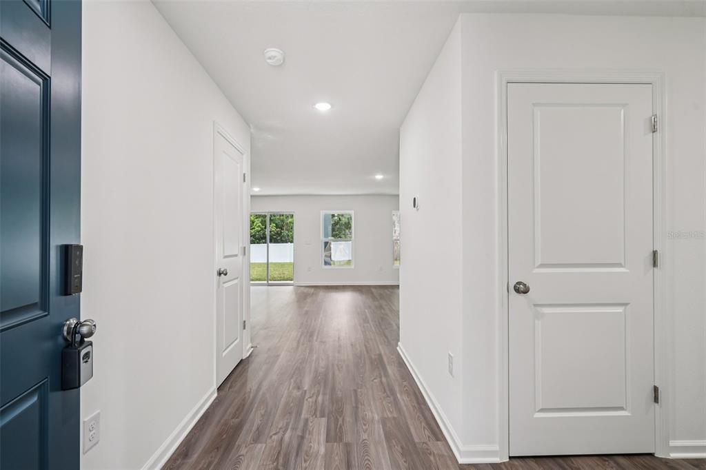 2155 Northwest 23rd Loop Ocala, FL 34475 - Photo 4 of 24 a view of a hallway with wooden floor and staircase