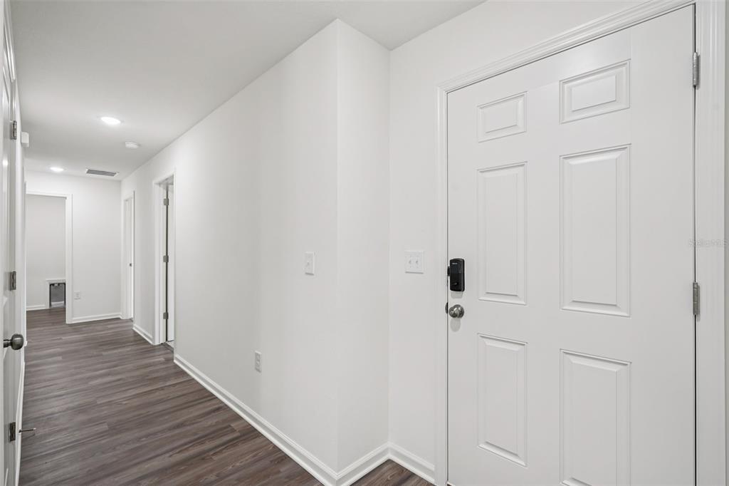 2155 Northwest 23rd Loop Ocala, FL 34475 - Photo 5 of 24 a view of a hallway with wooden floor