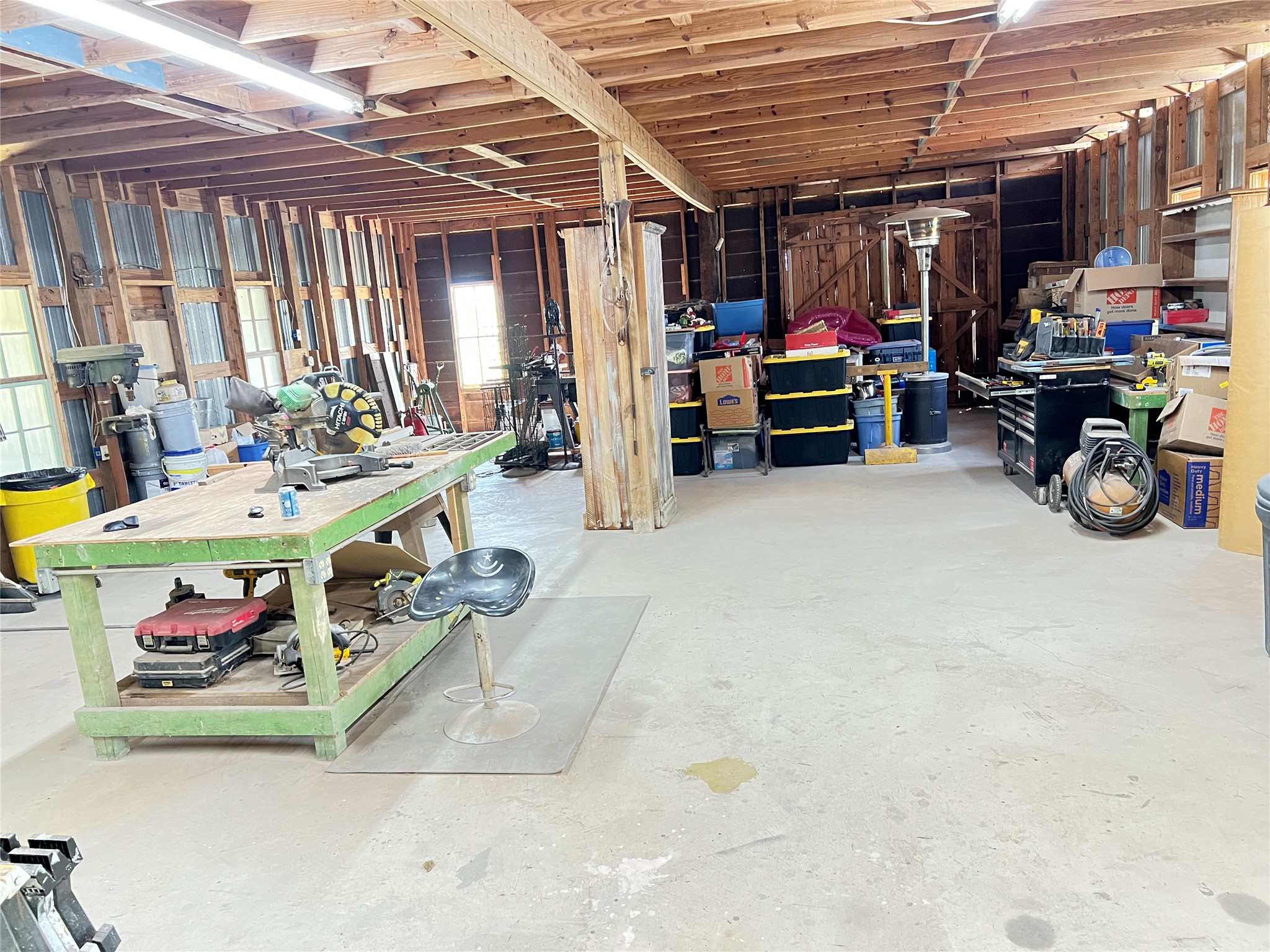 2421 Post Oak Road Webberville, TX 78653 - Photo 28 of 36 Featuring a 1,680 square foot concrete ground floor and a 1,200 square foot plywood second floor accessible by a permanent staircase.