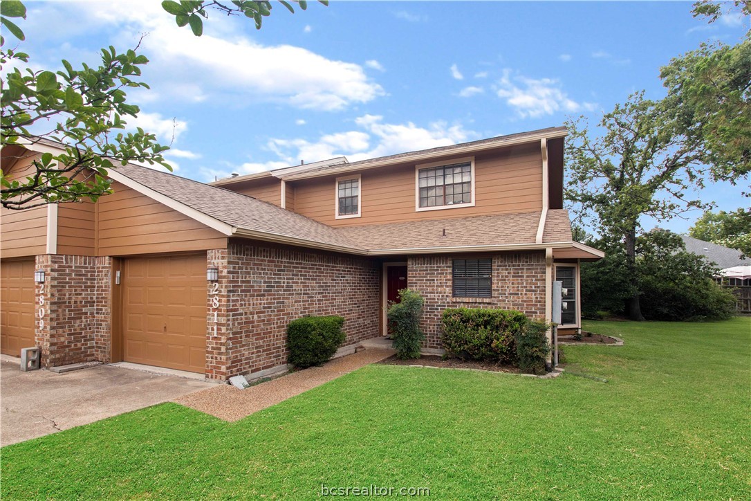 2811 Oakside Drive Bryan, TX 77802 - Photo 1 of 1 a front view of a house with a garden