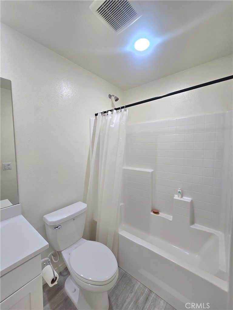 6451 Canyonlands Drive Jurupa Valley, CA 92509 - Photo 12 of 23 a white toilet and shower sitting next to a bathroom sink