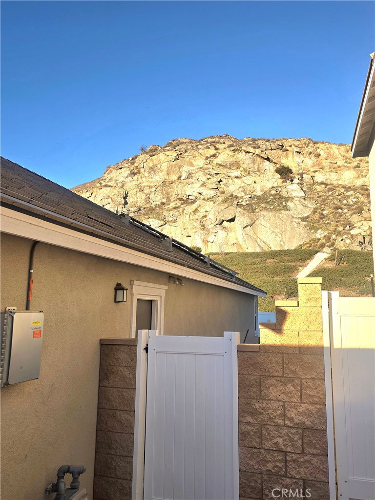 6451 Canyonlands Drive Jurupa Valley, CA 92509 - Photo 16 of 23 a view of a blue house with a big yard