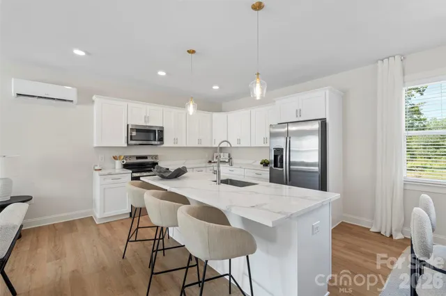 a kitchen with a sink stainless steel appliances and cabinets