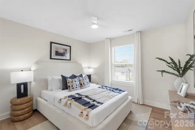 a bedroom with bed and wooden floor