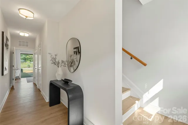 a view of a hallway with wooden floor
