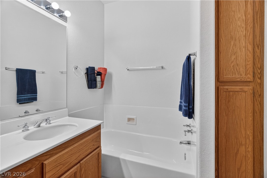 3376 Partridge Run Street Laughlin, NV 89029 - Photo 34 of 92 Functional full bathroom with ample storage and a clean, inviting aesthetic.