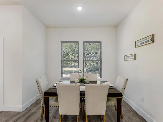 a view of a dining room with furniture and a window