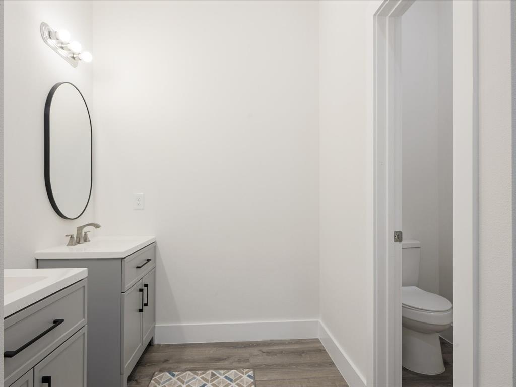 6123 Inca Drive Mabank, TX 75156 - Photo 21 of 32 a bathroom with a granite countertop sink and a mirror