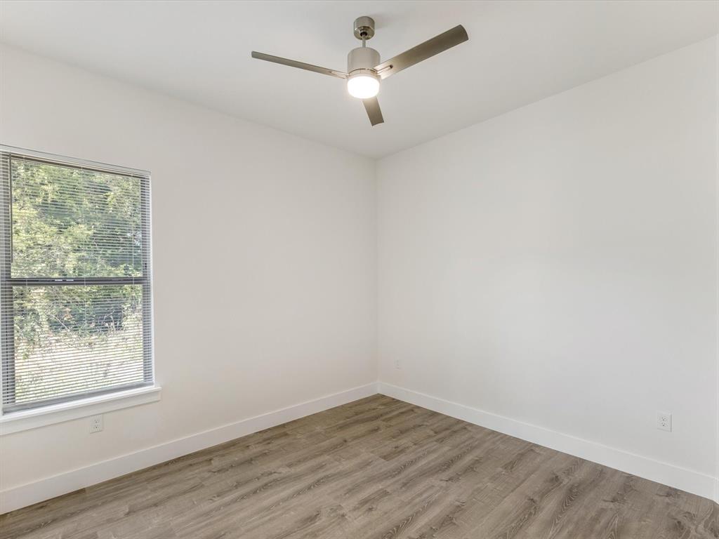 6123 Inca Drive Mabank, TX 75156 - Photo 26 of 32 an empty room with wooden floor and windows
