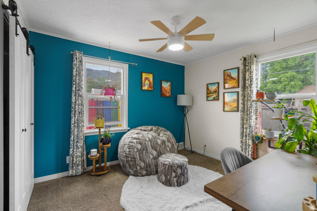 961 33rd Street Ogden, UT 84403 - Photo 19 of 39 Bright interior space featuring a ceiling fan with light fixture, dual windows, and barn door entry