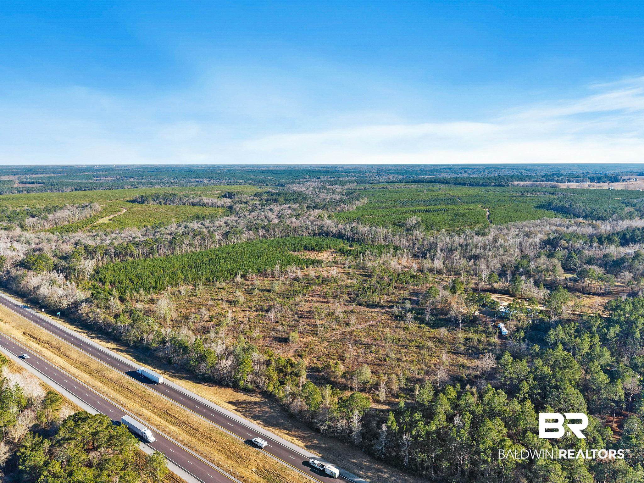 55750 Lottie Road Perdido, AL 36562 - Photo 7 of 84 Aerial view of property and surrounding area with rural landscape and large plots for crops