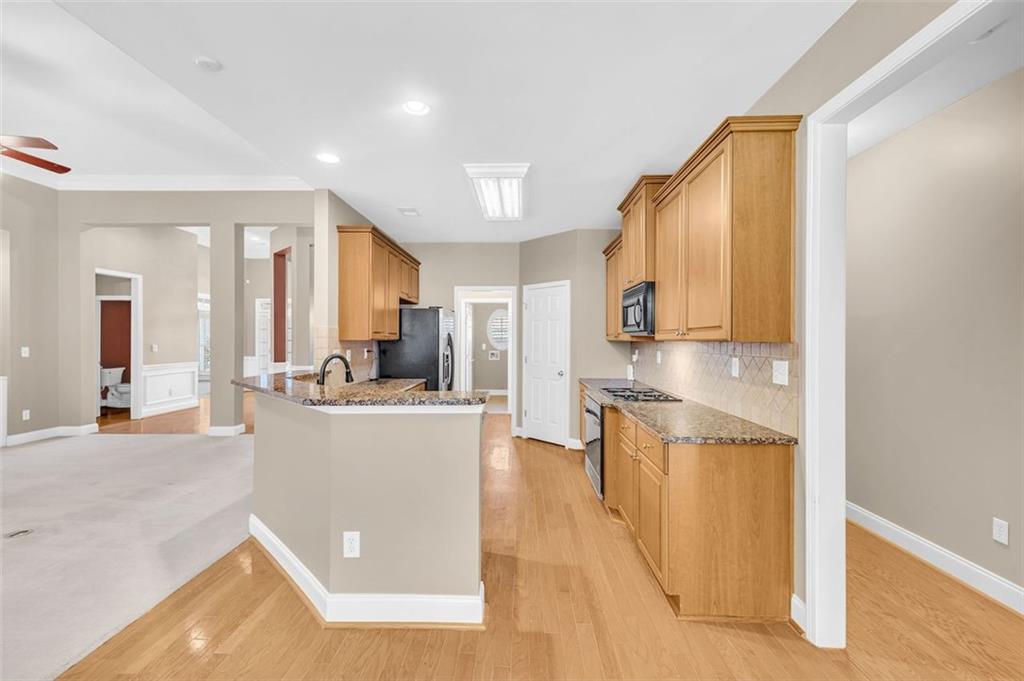 2403 Bonshaw Lane Southwest Marietta, GA 30064 - Photo 18 of 47 a view of a kitchen with kitchen island a counter top space a sink a refrigerator and cabinets