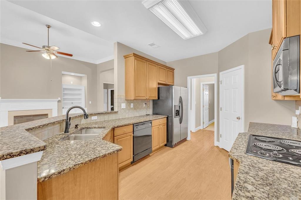 2403 Bonshaw Lane Southwest Marietta, GA 30064 - Photo 19 of 47 a kitchen with granite countertop a sink stove and refrigerator
