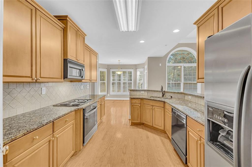 2403 Bonshaw Lane Southwest Marietta, GA 30064 - Photo 20 of 47 a large kitchen with stainless steel appliances granite countertop a lot of counter space and a sink