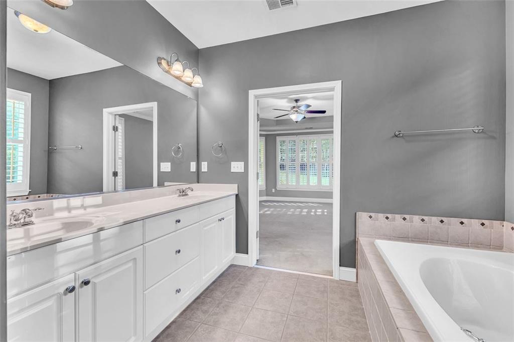 2403 Bonshaw Lane Southwest Marietta, GA 30064 - Photo 28 of 47 a spacious bathroom with a tub sink and mirror