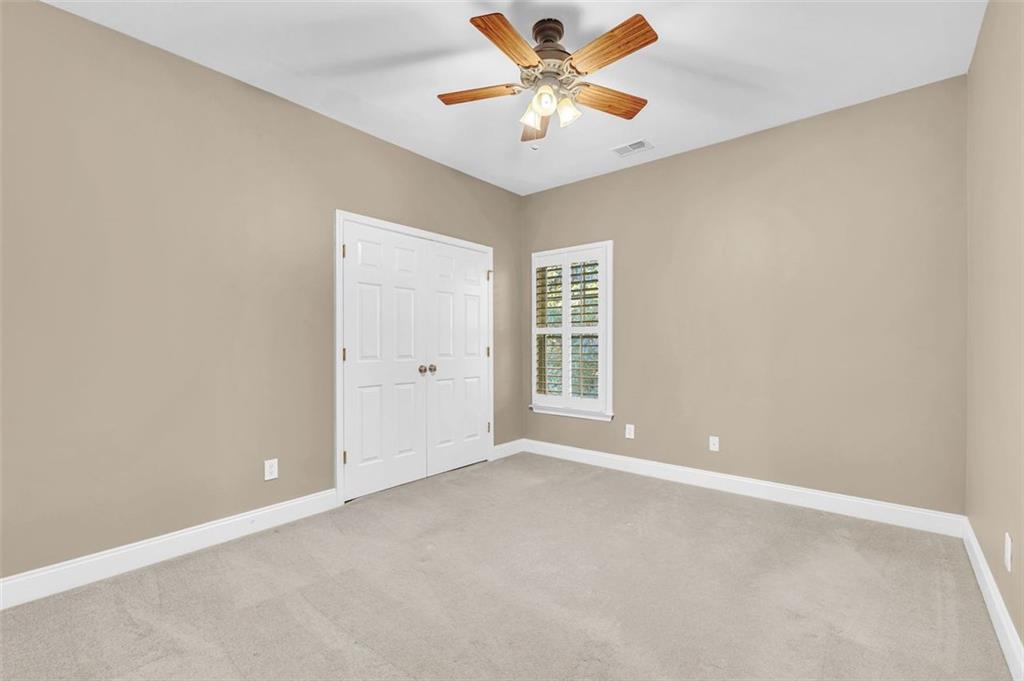 2403 Bonshaw Lane Southwest Marietta, GA 30064 - Photo 29 of 47 an empty room with windows and fan