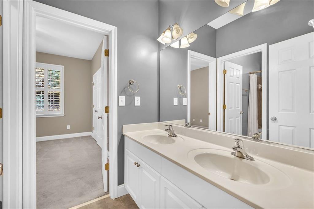 2403 Bonshaw Lane Southwest Marietta, GA 30064 - Photo 30 of 47 a bathroom with double vanity sinks and a mirror