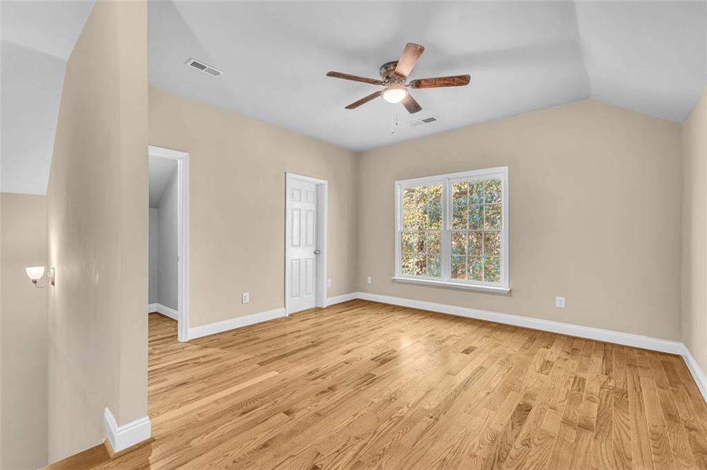 2403 Bonshaw Lane Southwest Marietta, GA 30064 - Photo 32 of 47 a view of an empty room with wooden floor and a window