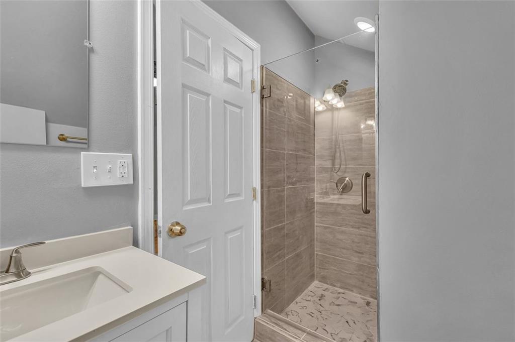 2403 Bonshaw Lane Southwest Marietta, GA 30064 - Photo 35 of 47 a bathroom with a shower sink and mirror