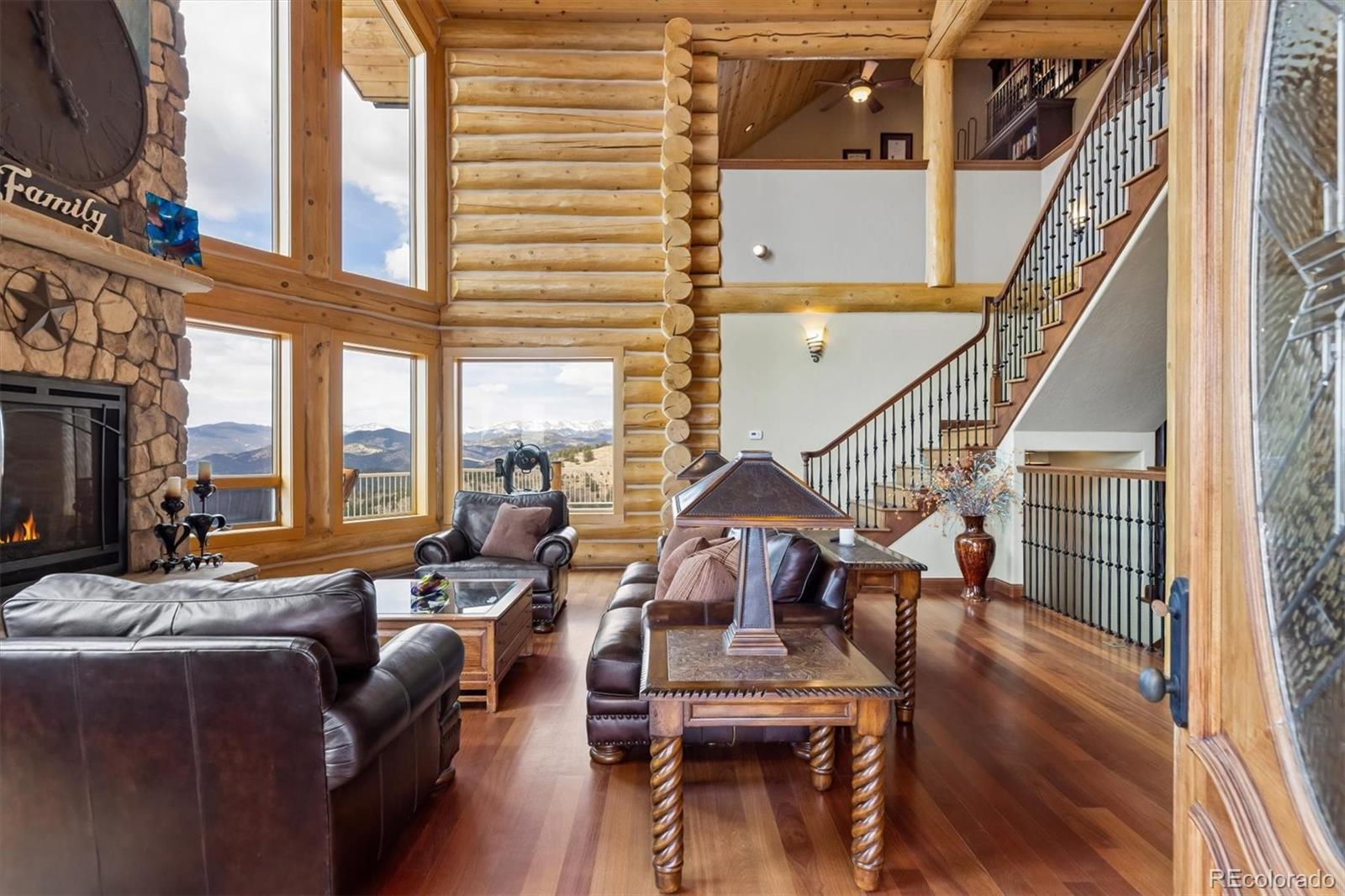 401 Raptor Point Golden, CO 80403 - Photo 16 of 48 a living room with furniture a fireplace and a floor to ceiling window