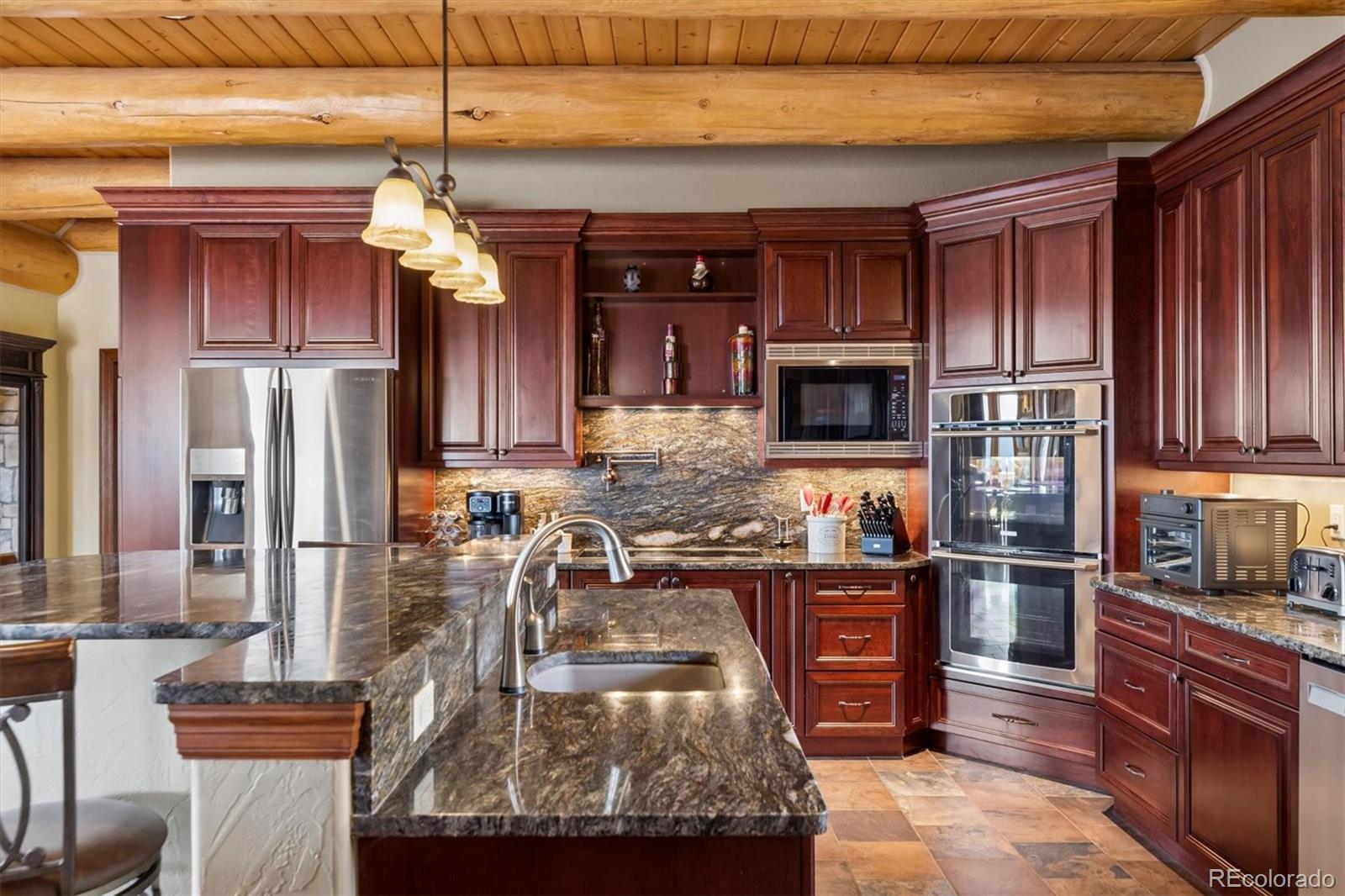 401 Raptor Point Golden, CO 80403 - Photo 20 of 48 a kitchen with stainless steel appliances granite countertop a refrigerator and a stove top oven