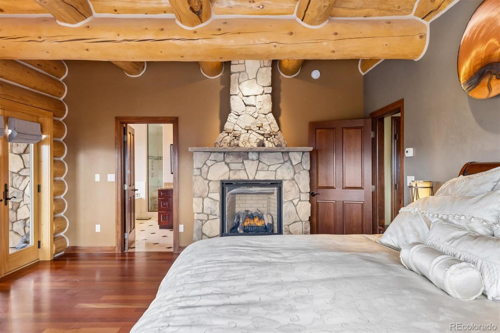 401 Raptor Point Golden, CO 80403 - Photo 26 of 48 a bedroom with a bed and a fireplace