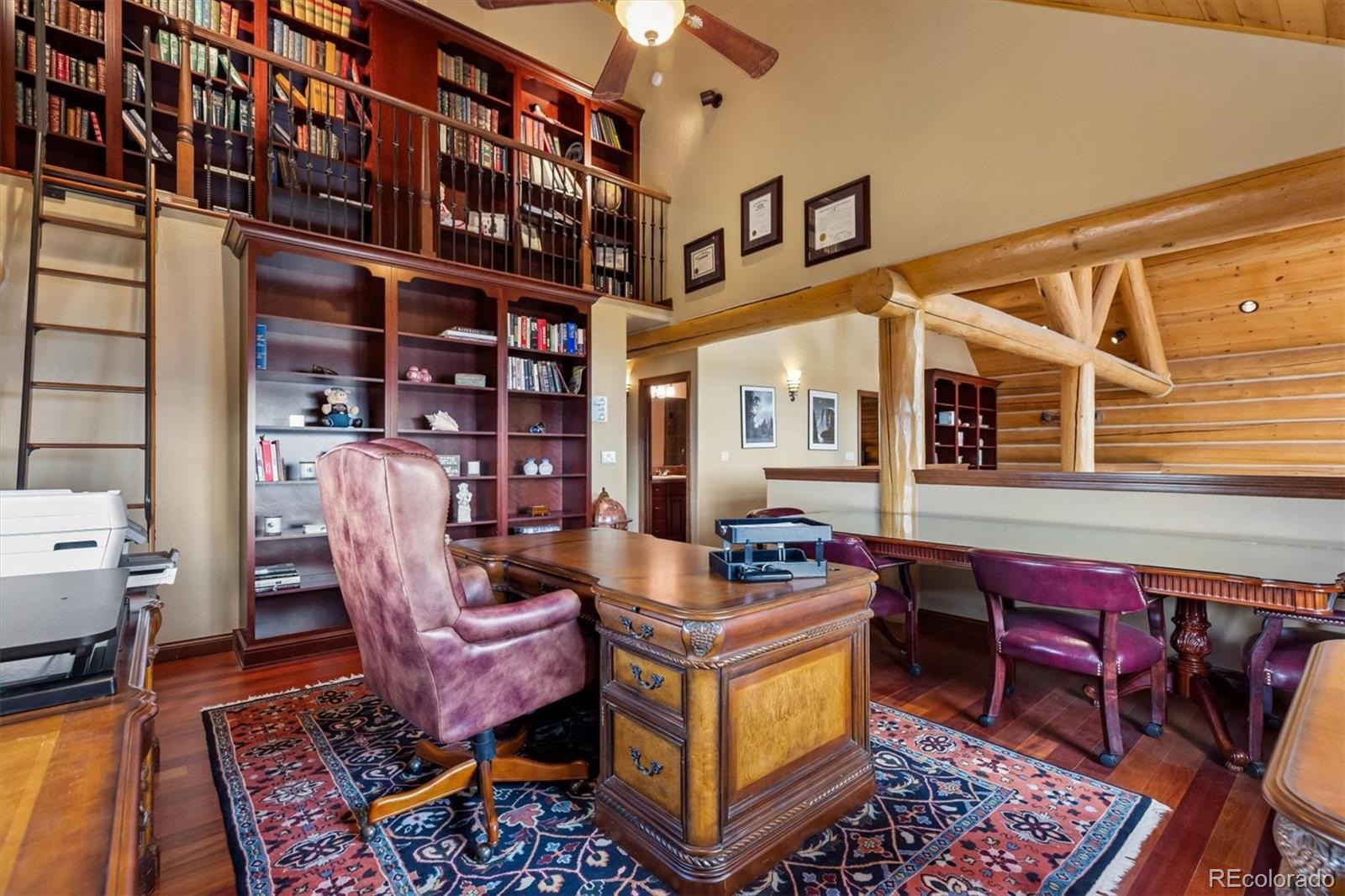 401 Raptor Point Golden, CO 80403 - Photo 31 of 48 a living room with furniture a rug and a bookshelf