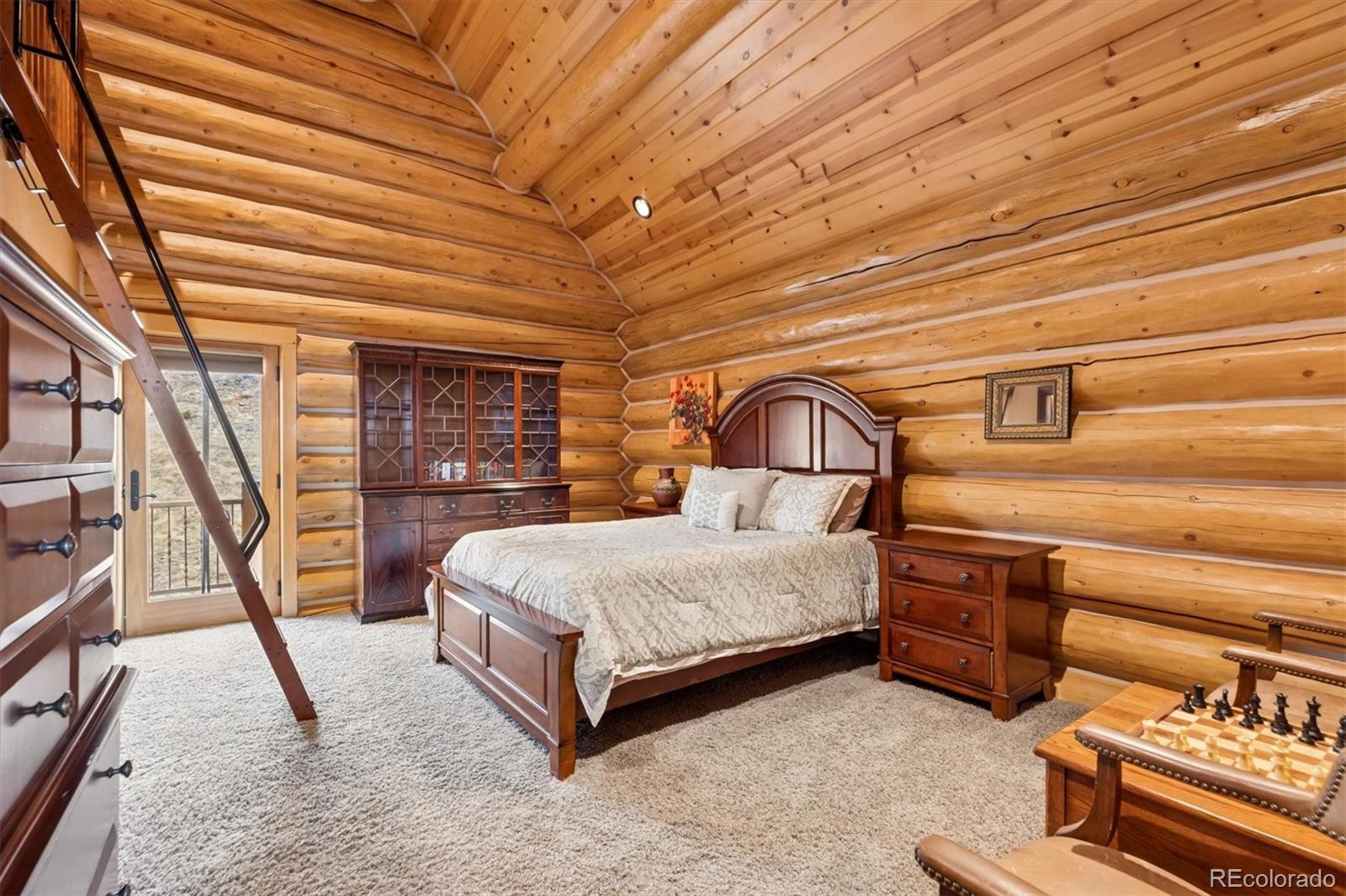 401 Raptor Point Golden, CO 80403 - Photo 32 of 48 a spacious bedroom with a bed and a table