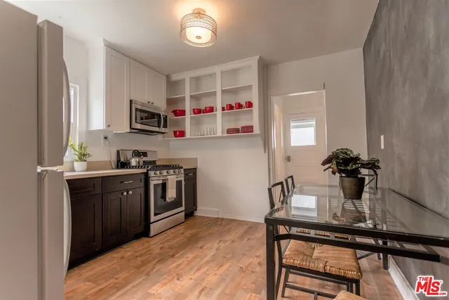 a kitchen with stainless steel appliances granite countertop a refrigerator stove a sink and a microwave