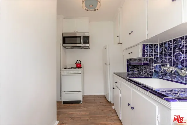 a bathroom with a sink mirror toilet and shower