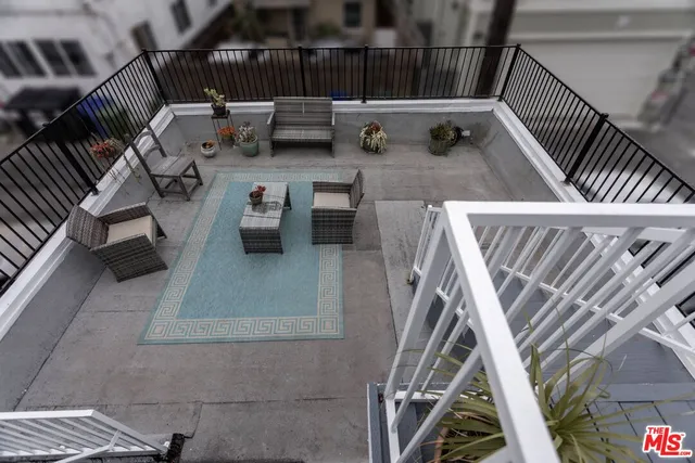 a room with a table chairs and refrigerator