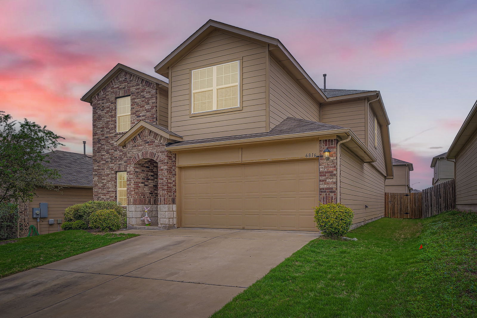6816 Ranchito Drive Austin, TX 78744 - Photo 1 of 1 Traditional home with an attached garage, a front lawn, driveway, and fence