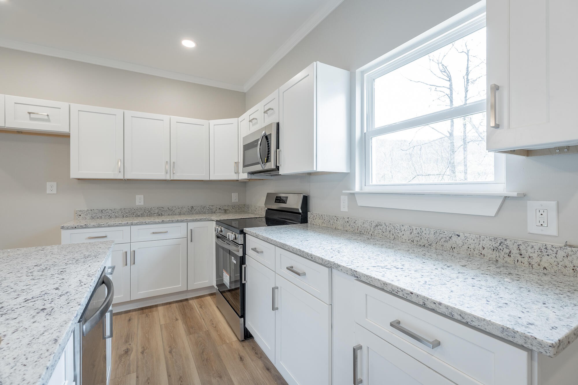 77 Pineway Circle Wildwood, GA 30757 - Photo 22 of 52 a kitchen with granite countertop white cabinets and white appliances