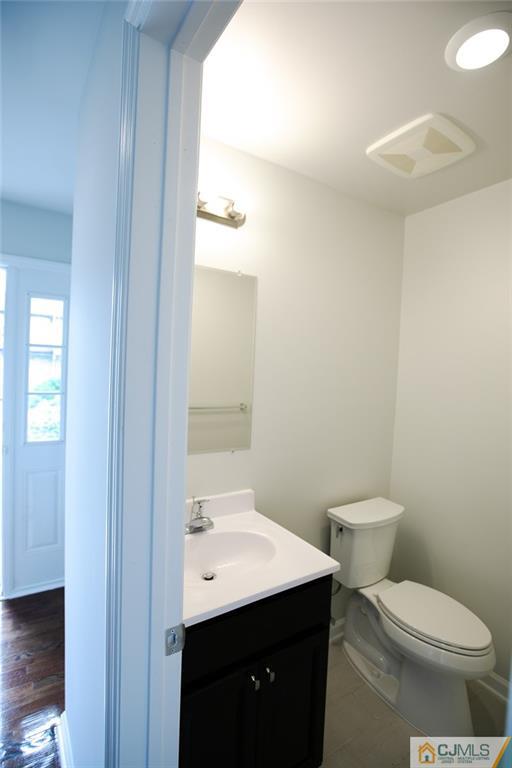 3507 Hana Road Edison, NJ 08817 - Photo 3 of 18 a bathroom with a toilet a sink and mirror