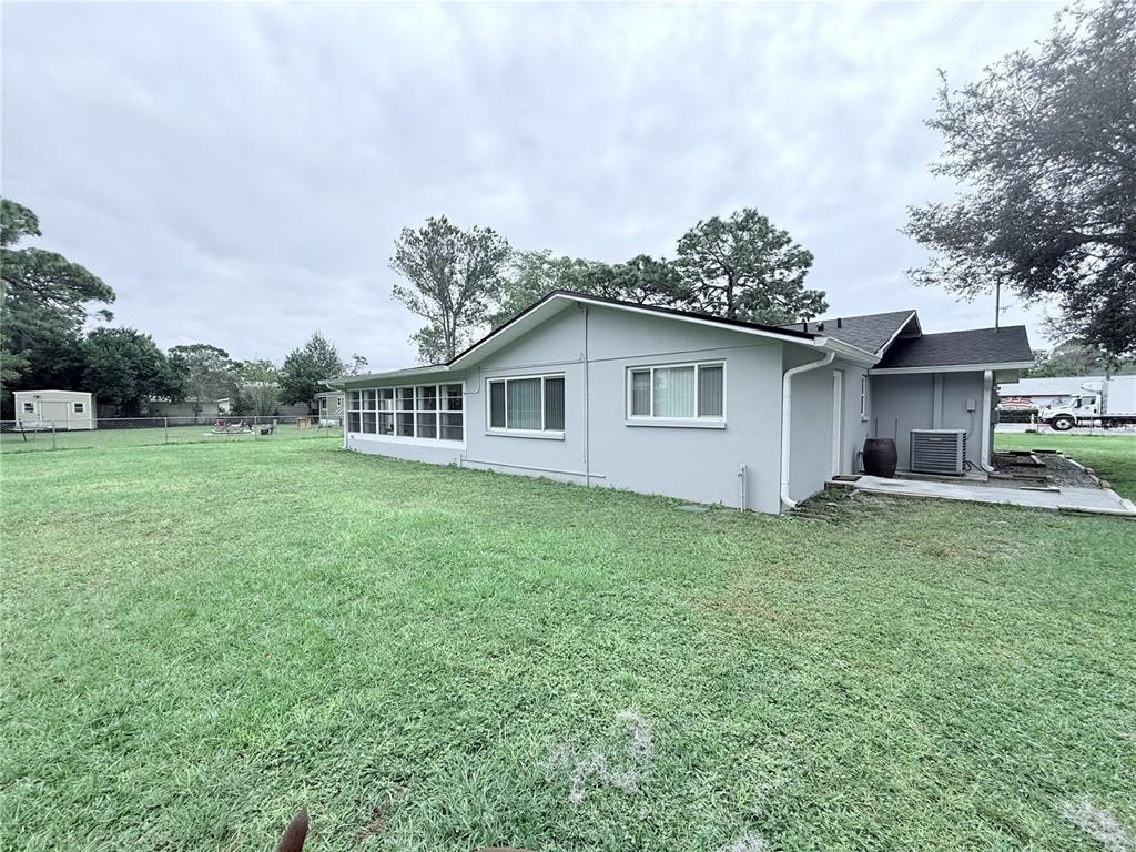 9733 Dick Street Hudson, FL 34669 - Photo 16 of 40 a backyard of a house with lots of green space