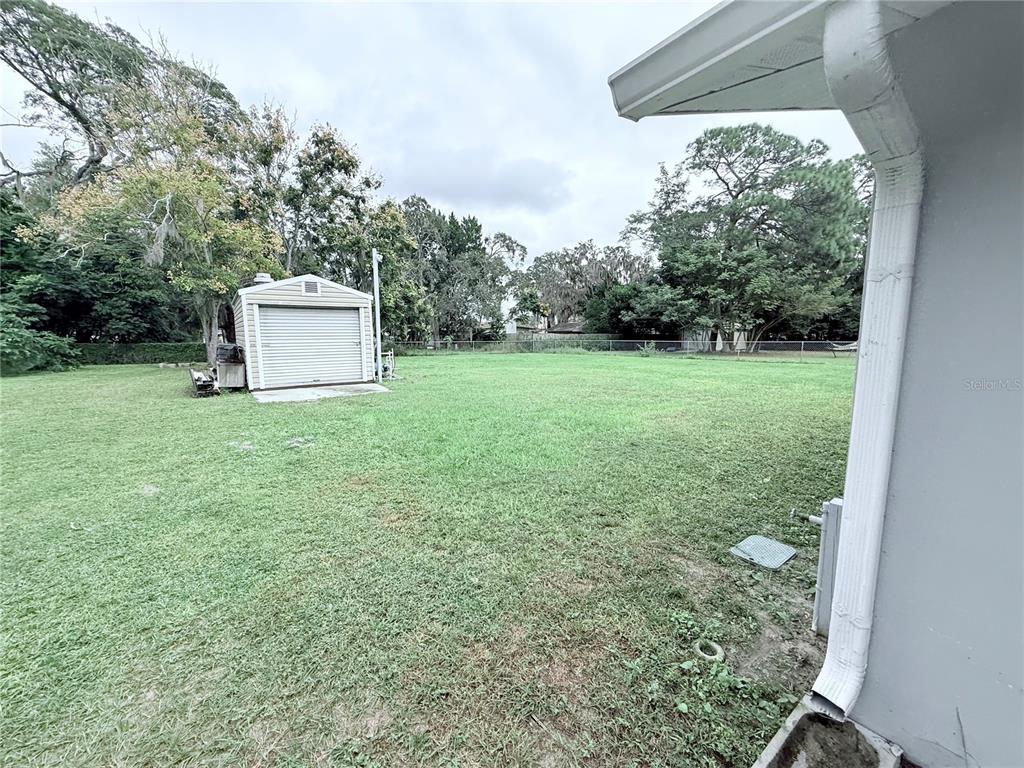 9733 Dick Street Hudson, FL 34669 - Photo 17 of 40 a view of a tiny house with a yard