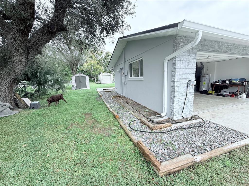 9733 Dick Street Hudson, FL 34669 - Photo 18 of 40 a front view of a house with garden