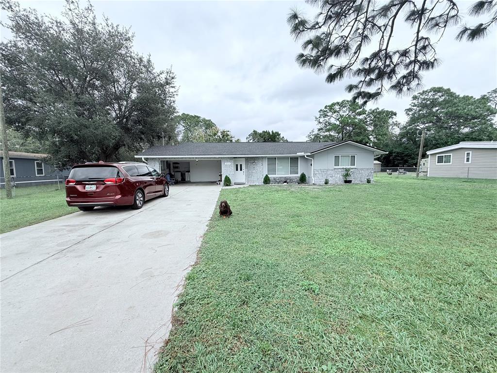 9733 Dick Street Hudson, FL 34669 - Photo 20 of 40 a car parked in front of white house