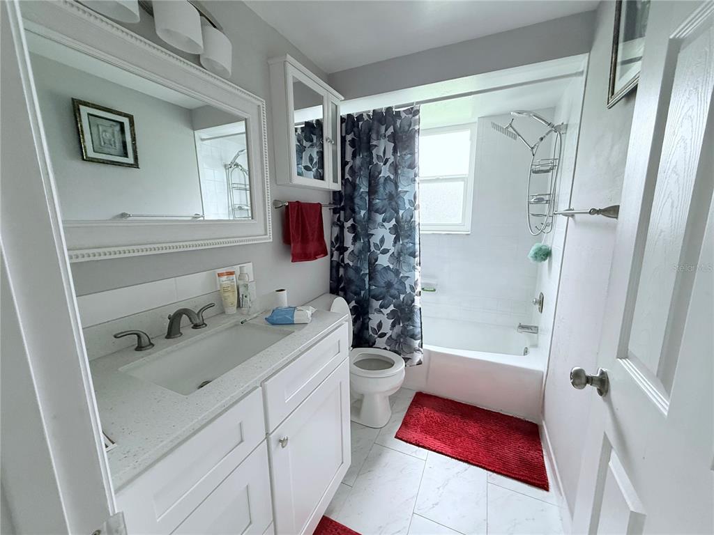 9733 Dick Street Hudson, FL 34669 - Photo 28 of 40 a bathroom with a sink toilet and shower