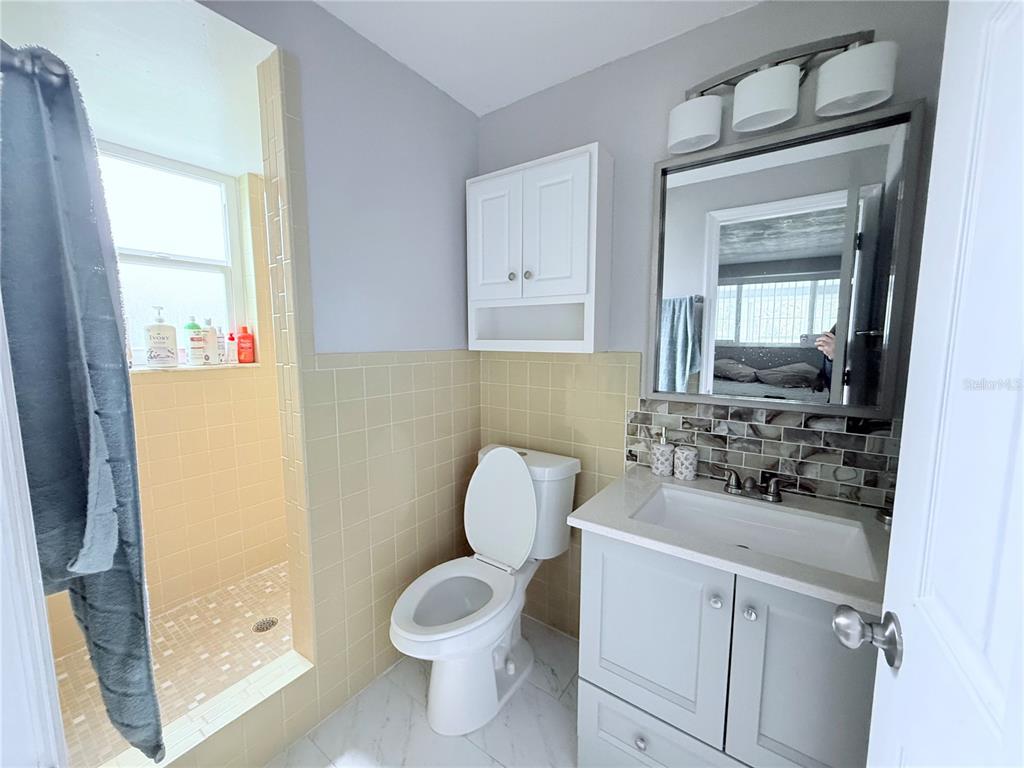 9733 Dick Street Hudson, FL 34669 - Photo 29 of 40 a bathroom with a toilet sink and mirror