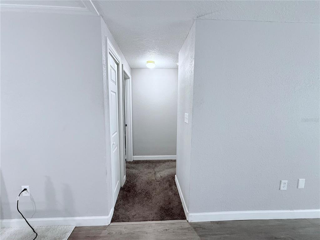 9733 Dick Street Hudson, FL 34669 - Photo 30 of 40 a view of hallway with wooden floor