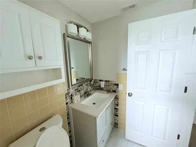 a kitchen with sink cabinets and wooden floor