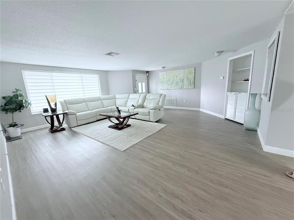 9733 Dick Street Hudson, FL 34669 - Photo 32 of 40 a living room with furniture window and wooden floor