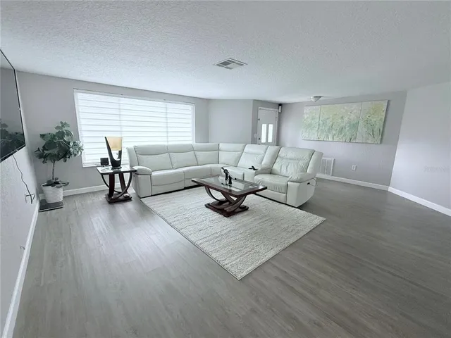 a kitchen with stainless steel appliances a sink a stove a refrigerator and cabinets