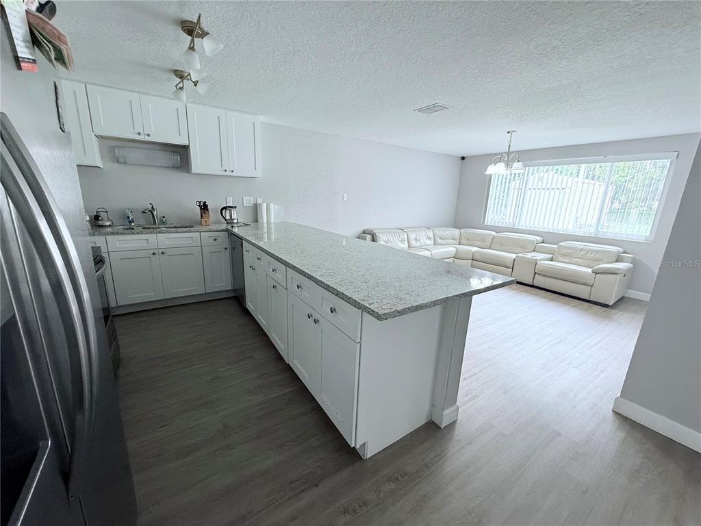 9733 Dick Street Hudson, FL 34669 - Photo 34 of 40 a kitchen with sink cabinets and wooden floor