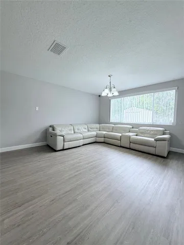 a view of a kitchen and dining area with chandelier