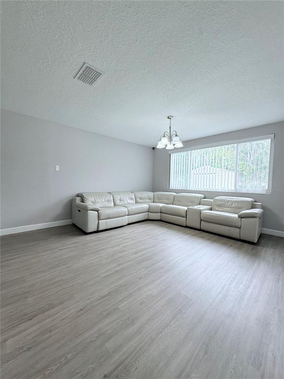 9733 Dick Street Hudson, FL 34669 - Photo 35 of 40 a view of a livingroom with furniture wooden floor and windows