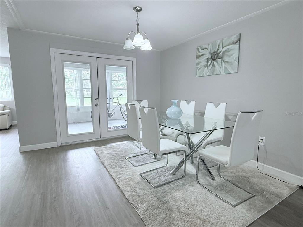 9733 Dick Street Hudson, FL 34669 - Photo 37 of 40 a view of a dining room with furniture and wooden floor
